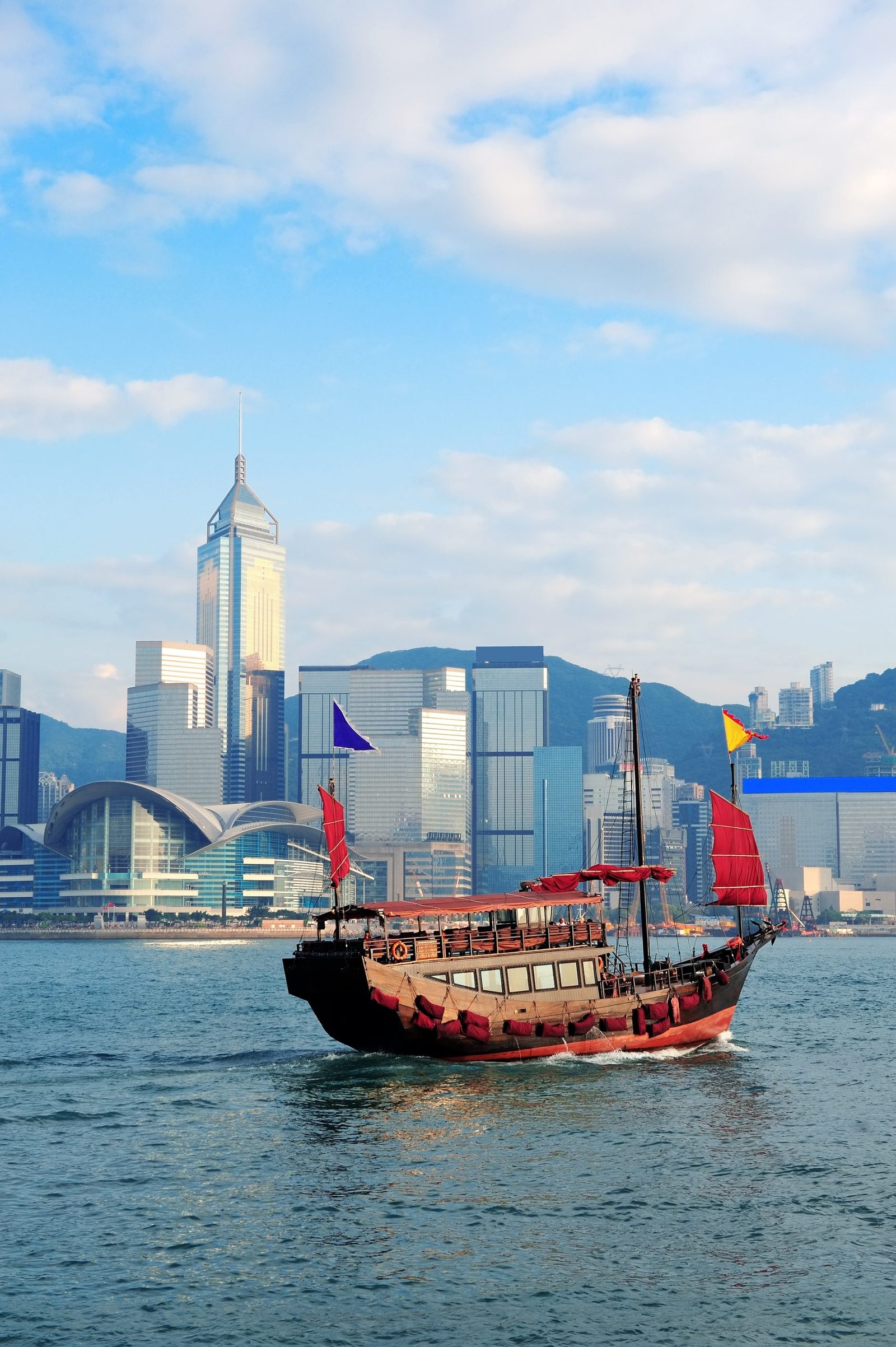 Hong Kong skyline with boats in Victoria Harbor.