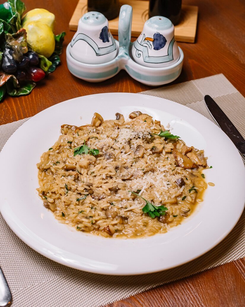 mushroom-risotto-plate-garnished-with-grated-parmesan-parsley_141793-1934